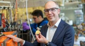 Image of Zach Smith holding a "membrane coupon"